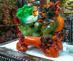 An emerald stone dragon sculpture on display in an antique market in a temple near Da Lat, Vietnam