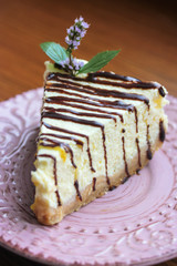 A piece of cheesecake on a pink plate, a delicious and healthy dessert.