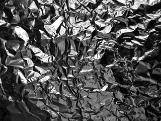 Abstract texture pattern metallic paper using as a background or wallpaper. Metal aluminum foil shiny and reflector