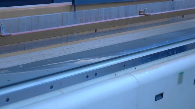 Production of laminated veneer lumber on plant on cutting machine equipment. The production line for wood. Woodworking timber industry: machinery and equipment for press and cutting of lumber.