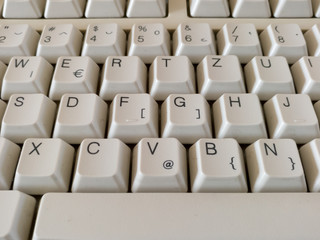 A close-up view of the computer peripheral or hardware, detail from the keyboard, letters and numbers on the buttons, qwertz layout of letters.