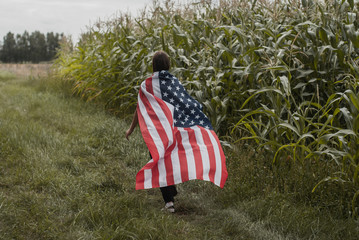 A girl runs with an American flag
