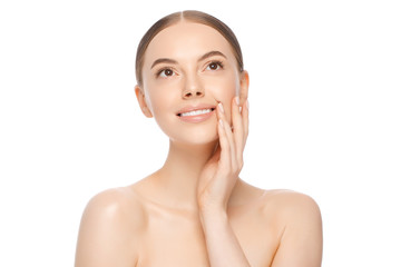 Portrait of young pensive dreamful smiling beautiful female with brown eyes and glowing naked skin, looking above, isolated on white background