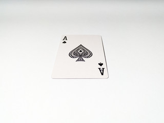 A close up view at one ace card with a spade suit from a deck of playing cards. The concept of games, gambling, fun and free time.