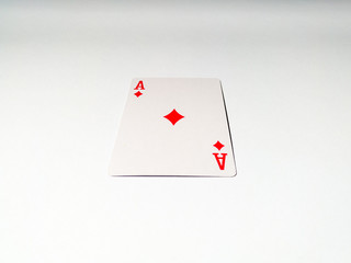 A close up view at one ace card with a diamond suit from a deck of playing cards. The concept of games, gambling, fun and free time.