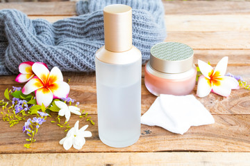 the therapy first serum toners with cotton ,eyes cream natural cosmetics extract herbal health care for skin face and knitting wool of lifestyle woman relax arrangement flat lay style on wooden