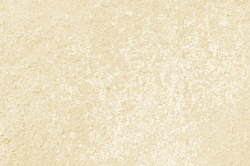 Fototapeta na wymiar Beige wall of the building. Rough plaster surface. Abstract background.