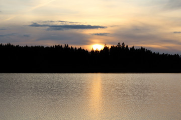 Beautiful mystical sunset on the north lake. Dramatic sky background.