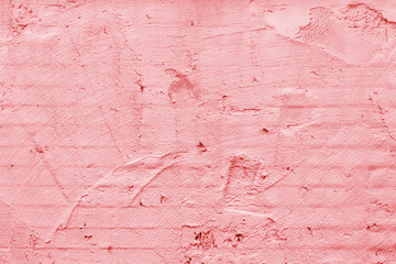 Pink wall of the building. Rough plaster surface. Abstract background.