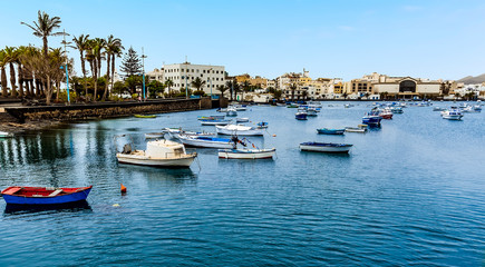 Fototapeta na wymiar Small boats moored in the lagoon of Charco de San Gines in Arrecife, Lanzarote on a sunny afternoon