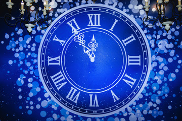 Blue clock face showing five minutes to midnight. New Year. Christmas.