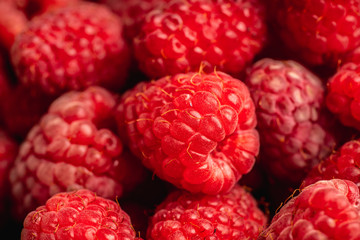 Ripe and juicy raspberry on the dark rustic background. Selective focus. Shallow depth of field.