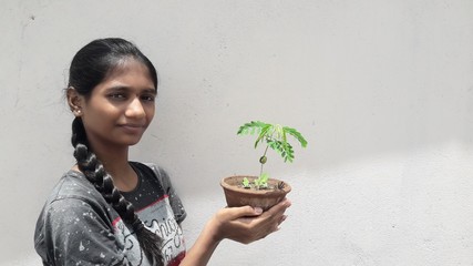 young woman holding plant