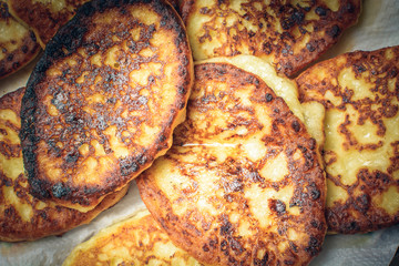 Curd cheesecakes on white napkin to absorb excess oil.