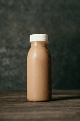 fresh coffee drink on a plastic bottle over dark background