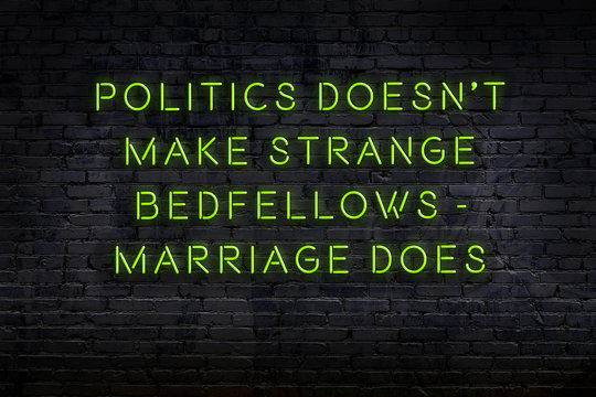 Wise quote. Neon inscription against brick wall