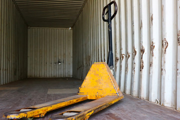 The yellow forklift is in the container.