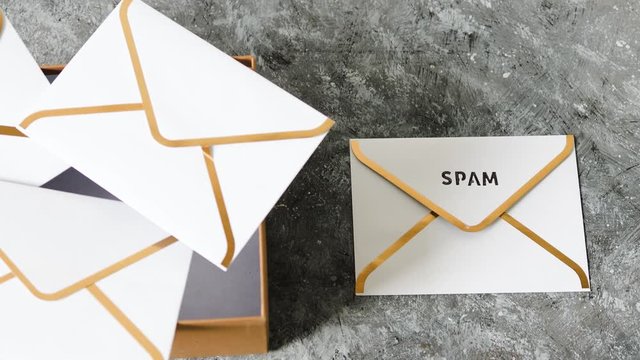 inbox organisation, group of envelopes inside box metaphor of email inbox and one marked spam outside of it with camera tilting
