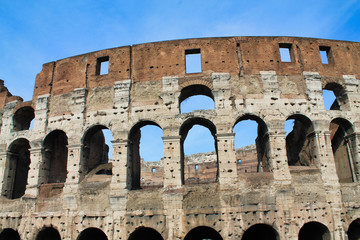 Obraz premium Part of Colosseum against a blue sky, rome