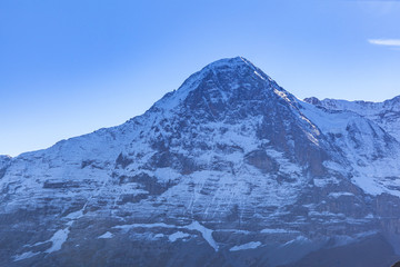 Stunning close up view of the north face of Eiger in autumn, famous cliff of Swiss Alps for mountaineering on Bernese Oberland, from Mannlichen, Canton of Bern, Switzerland