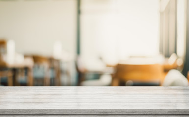 Empty wood table on blur restaurant background.