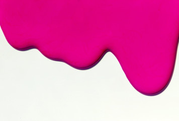 
Pink paint spreads on a white background.Copy space.