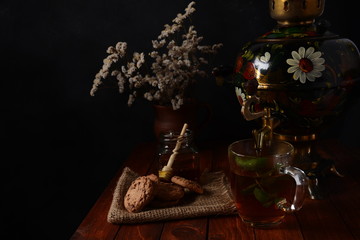 Tea Party in rustic style with samovar
a glass in glass holder, honey and cookies