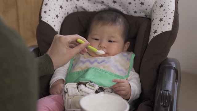 Pov Shot Of A Hungry Toddler Being Fed With Tasty Baby Food. Innocent Asian Baby Girl Loving Her Meal And Craving For More.