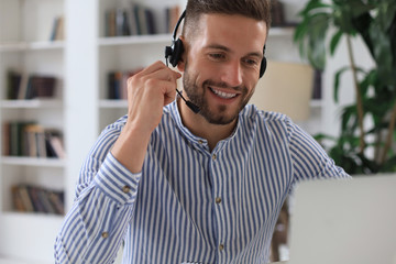 Smiling young business man having video call in office.