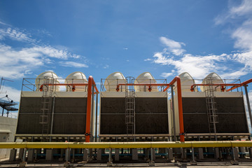 Cooling towers in data center building. Air conditioning cooling towers in front of building with...