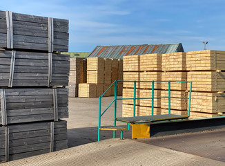 Stacked wooden pallets at wood sawmill and machinery