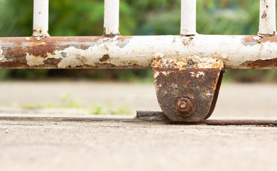 Close-up photo of the steel wheel, the door is rusted and has a very old and damaged condition because the maintenance is not performed.