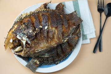 Deep fried Tilapia fish after fried on dish ready to eat