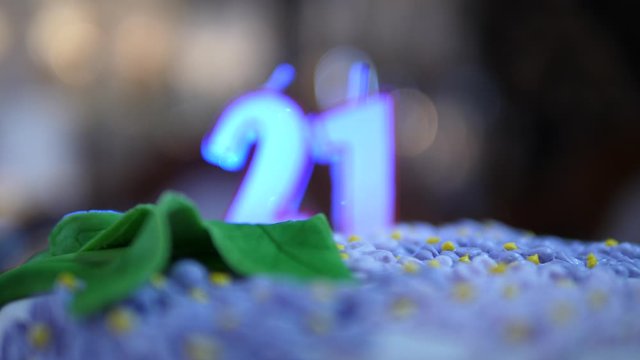 21 Birthday cake dolly zoom. Blue Candles number twenty one not burning. Isolated close up.
