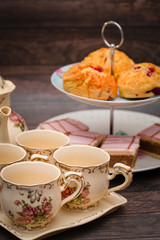 Cups of tea and cakes on the stand