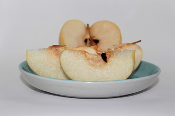 fresh pear on a plate on a white background