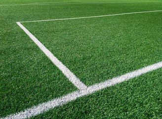 Fototapeta premium Stadium. Green grass soccer field with white markings.