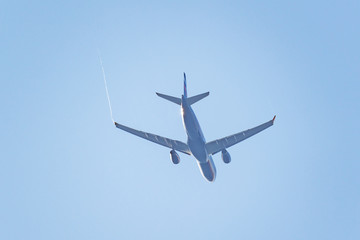 Fototapeta na wymiar Passenger plane flies in the blue sky.