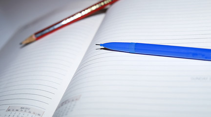 Close-up shot of opened diary and automatic pencil