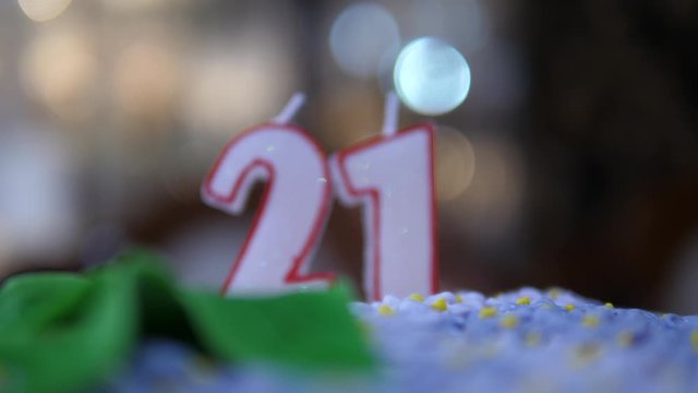 Candles number twenty one not burning. 21 Birthday cake dolly zoom. Isolated close up.