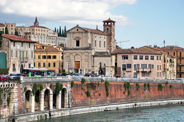 View of Lungadige Re Teodorico at historic centre of Verona. Colorful facades of old houses on waterfront of the Adige River. 