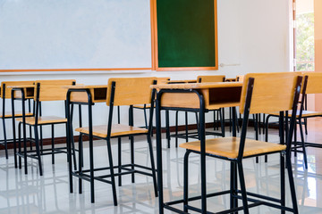 Classroom with wooden furniture without student, interior of row empty school in Thailand, Closed quarantine, no pupil in situation of Covid-19 disease outbreak result in inability organize learning