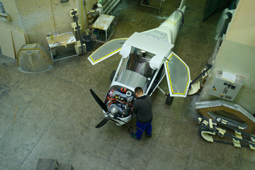 Light planes assembly hall, fitter assembling passenger plane