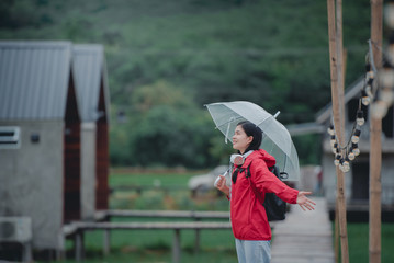 Beautiful young Asian tourists wearing red clothes travel in Thailand She likes to travel in nature.