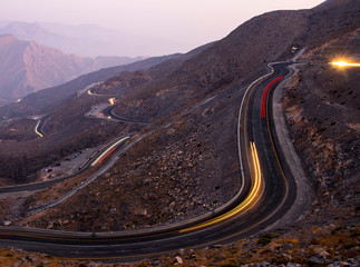 View from Jebael Jais mountain of Ras Al Khaimah emirate in the evening. United Arab Emirates, Light trails from the car
