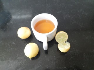 Cup of tea and lemon. tea in cup with  lemon isolated on black background. lemon tea with lemon. It is a Natural sources of Vitamin C.  It increases the immunity of our body. 