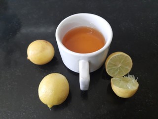 Cup of tea and lemon. tea in cup with  lemon isolated on black background. lemon tea with lemon. It is a Natural sources of Vitamin C.  It increases the immunity of our body. 