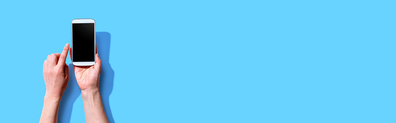 Person using a white smartphone from above