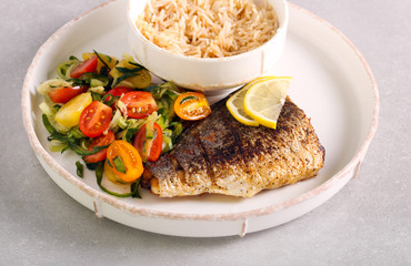 Fried sea bass fish fillet served