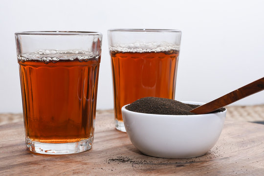 Indian Masala Chai black tea and tea dust,traditional beverage with or without milk and spices Kerala India. Two cups of organic ayurvedic or herbal drink India, good in winter for immunity boosting.